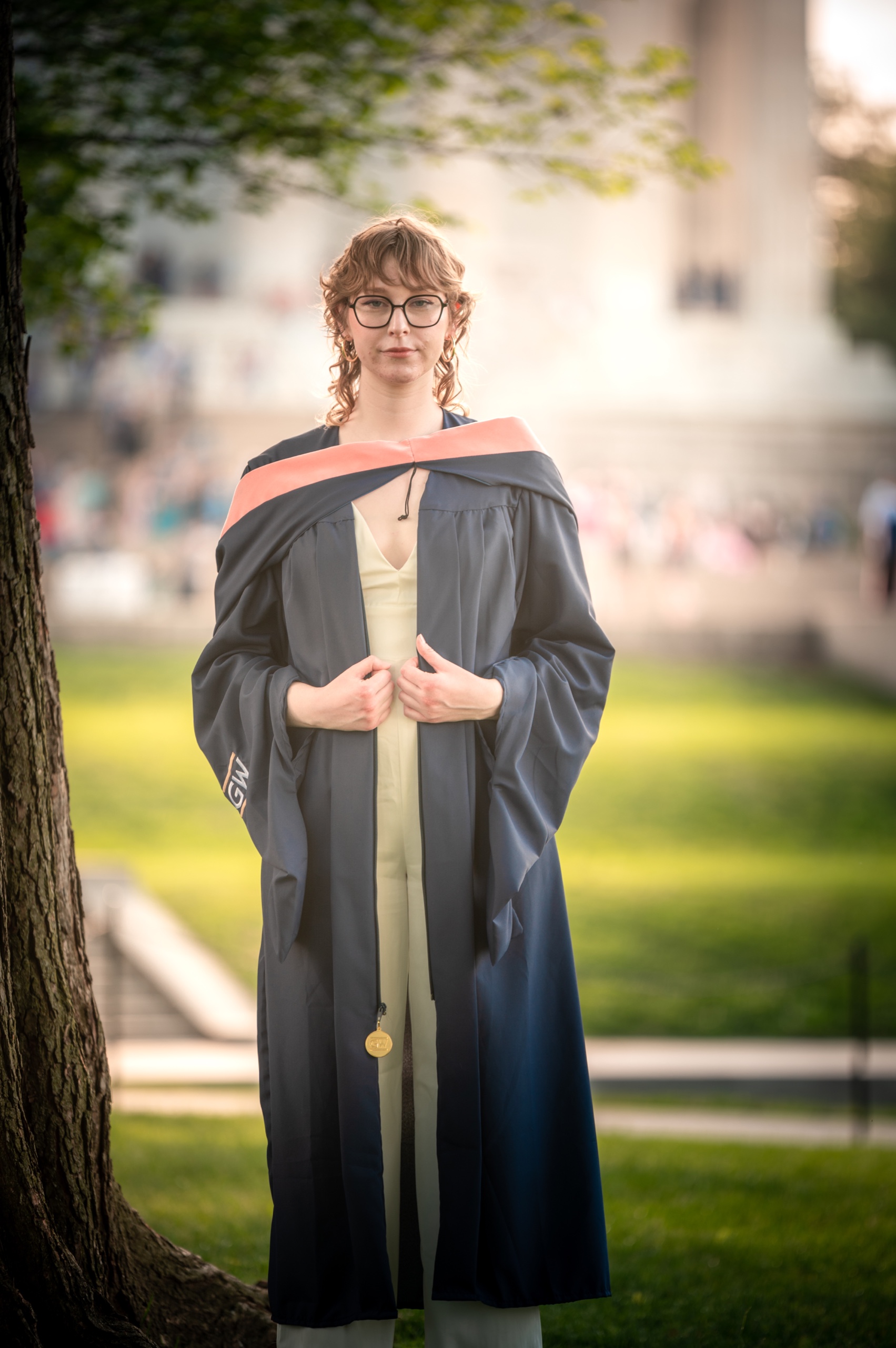 Graduate portrait with natural campus backdrop